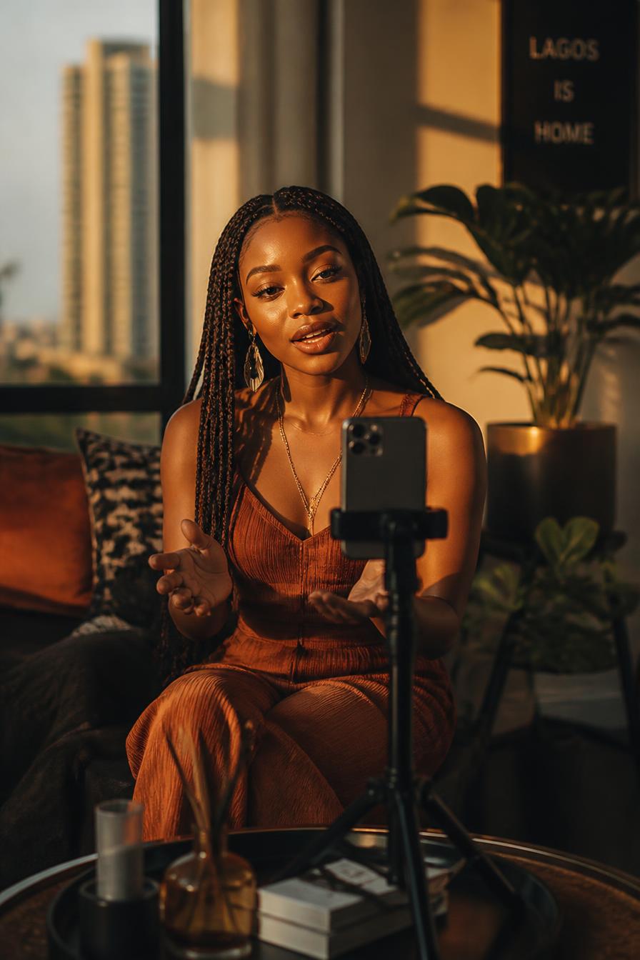 African content creator filming a vertical promotional video on a phone in Lagos